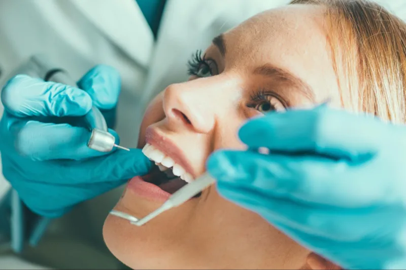 Orthodontist performing extraction therapy to a patient.
