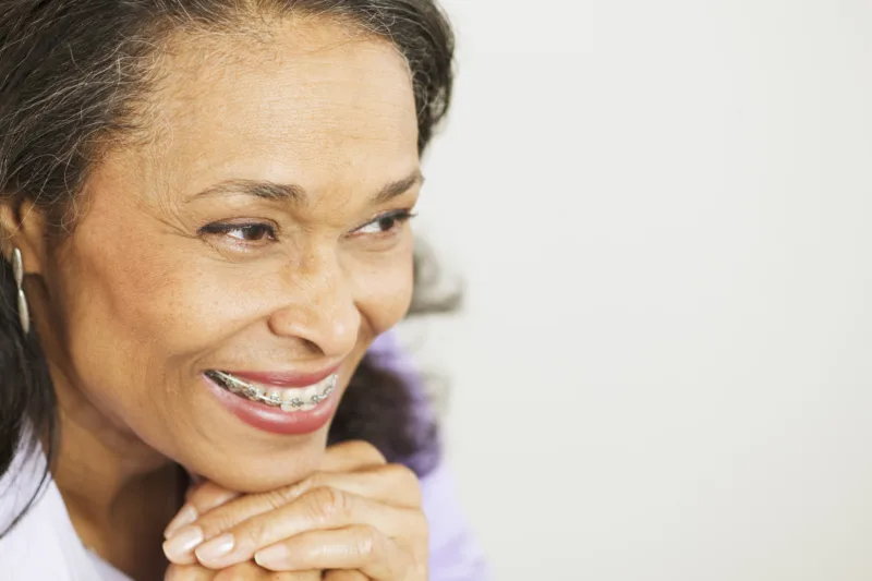 Senior patient wearing metal braces.