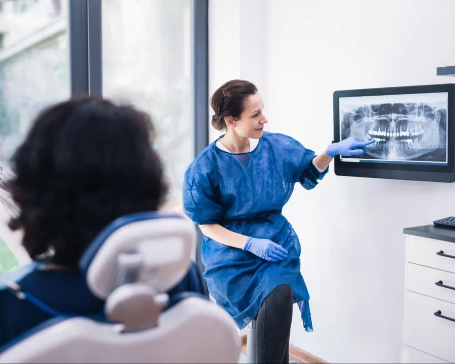Beam team going over an x-ray with the patient.