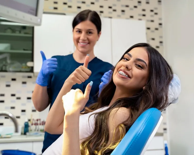 Patient smiling with their orthodontist.