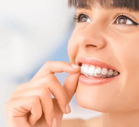 Patient taking out their clear retainers
