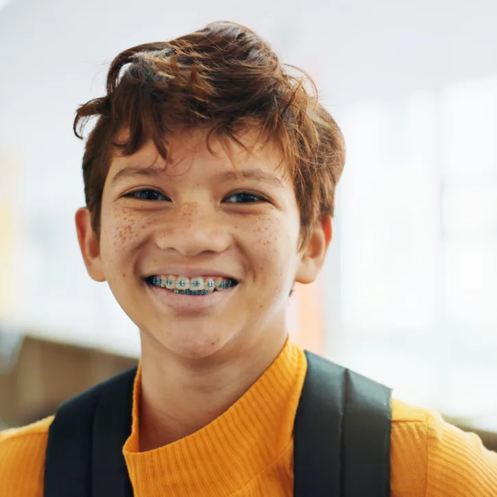 Young kid smiling with metal braces